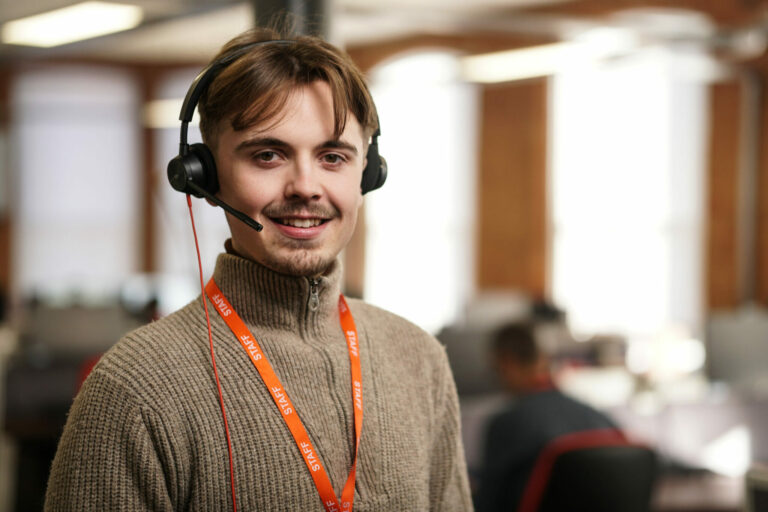 man sitting at a desk with a headset on