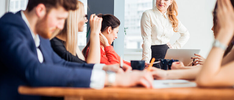 Staff sitting around a meeting table
