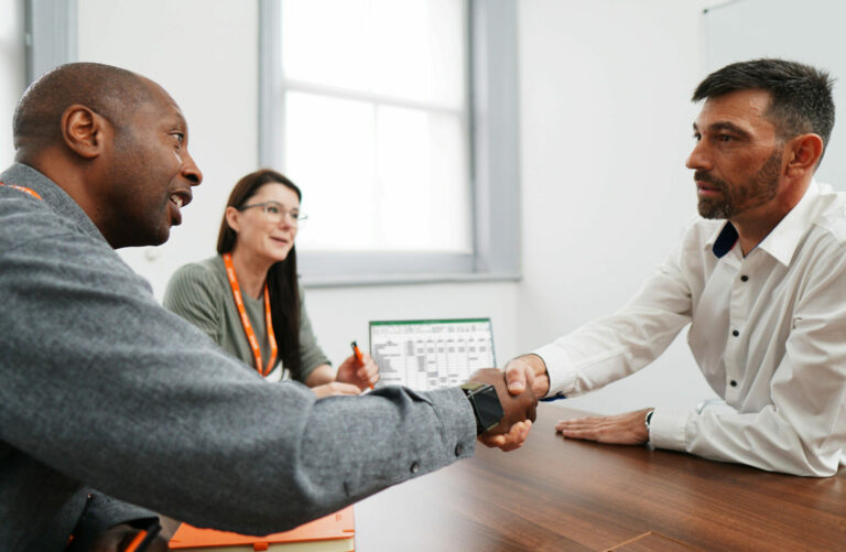 Staff Having A Meeting In A Meeting Room Around A Table